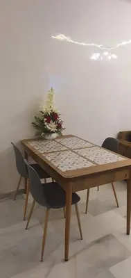 a wooden table with a christmas tree on top of it at Aerostay Jamal in Dah Hammou Ben Cheïkh
