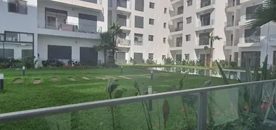 a view of a lawn in front of a building at Aerostay Jamal in Dah Hammou Ben Cheïkh