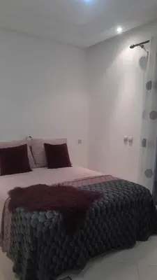 a bedroom with a bed with a blanket on it at Complex garden beach2 sidi rahal in Sidi Rahal