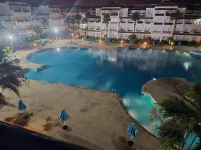an overhead view of a large swimming pool at night at Complex garden beach2 sidi rahal in Sidi Rahal
