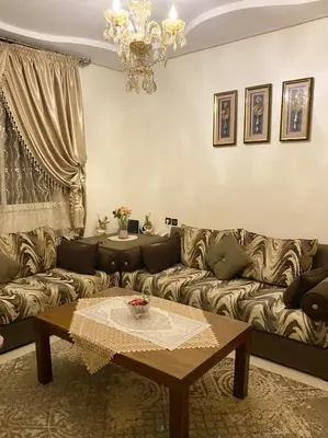 a living room with a couch and a table at Luxurious Holiday Home 2 in Temara