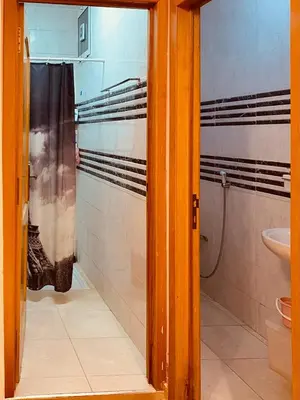 a bathroom with a shower and a toilet in it at Luxurious Holiday Home 2 in Temara
