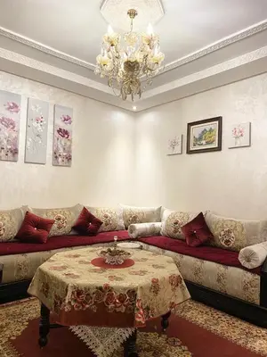 a living room with a couch and a chandelier at Luxurious Holiday Home 2 in Temara