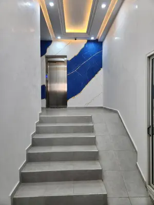 a staircase in a building with a blue wall at Résidence Rose Marie 24 lot 92A à côté de Harhoura in El Harhoura