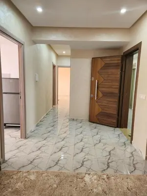 a hallway of a house with a door and marble floors at Résidence Rose Marie 24 lot 92A à côté de Harhoura in El Harhoura