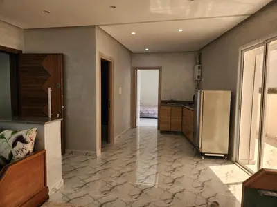a kitchen with a stainless steel refrigerator in a room at Résidence Rose Marie 24 lot 92A à côté de Harhoura in El Harhoura