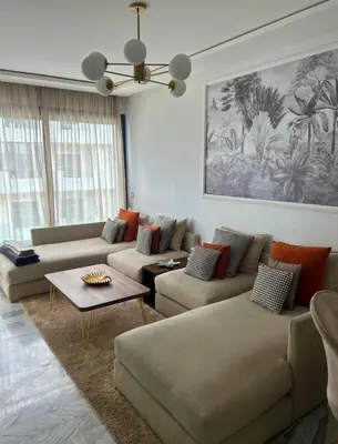 a living room with two couches and a table at Charmant appartement 2 chambres à Casablanca, à 10 min de la plage in Casablanca