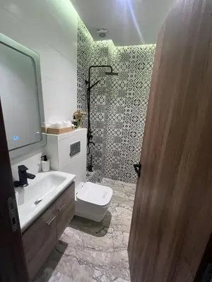 a bathroom with a toilet and a sink and a shower at Charmant appartement 2 chambres à Casablanca, à 10 min de la plage in Casablanca