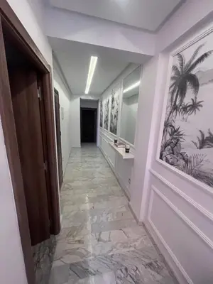 a hallway with a bathroom with a sink and a mirror at Charmant appartement 2 chambres à Casablanca, à 10 min de la plage in Casablanca