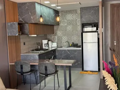 a kitchen with a table and chairs and a refrigerator at Modern City Centre Apartment in Casablanca