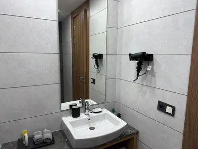 a bathroom with a sink and a mirror at Modern City Centre Apartment in Casablanca