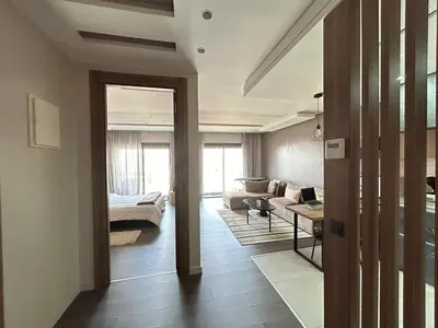 a living room with a couch and a table at Modern City Centre Apartment in Casablanca
