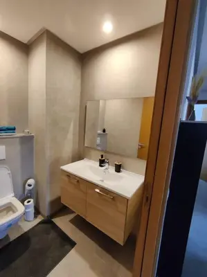 a bathroom with a sink and a toilet at Blue Themed Vacation Condo in Temara