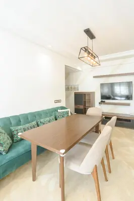 a living room with a table and a green couch at At Casablanca 's Home in Casablanca