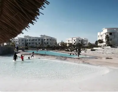 a group of people playing in the water at a beach at Golf City Prestigia Bouskoura in Bouskoura