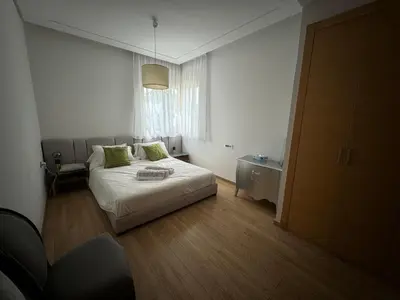 a small bedroom with a bed and a window at Golf City Prestigia Bouskoura in Bouskoura