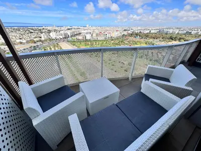 a balcony with chairs and a view of a city at CFC Luxury View Appt Anfa park in Casablanca