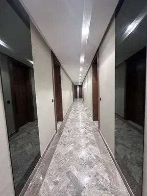 a corridor of an office building with marble floors and doors at CFC Luxury View Appt Anfa park in Casablanca