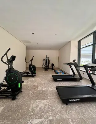 a gym with several treadmills and exercise bikes at CFC Luxury View Appt Anfa park in Casablanca