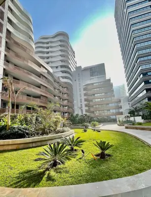a park in the middle of a city with tall buildings at CFC Luxury View Appt Anfa park in Casablanca