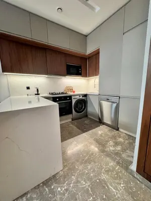 a white kitchen with a stove and a dishwasher at CFC Luxury View Appt Anfa park in Casablanca