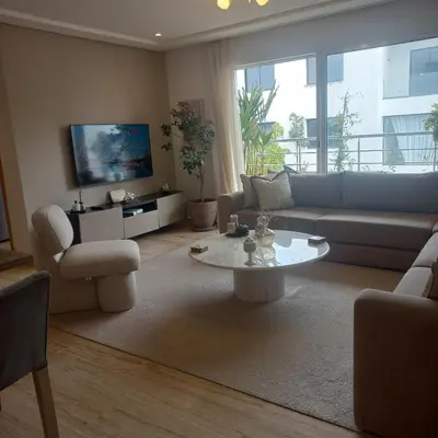 a living room with a couch and a table at Puerto Marina Dar Bouazza in Dar Bouazza