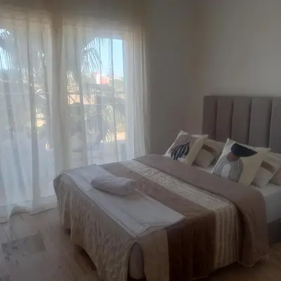 a bedroom with a large bed and a window at Puerto Marina Dar Bouazza in Dar Bouazza