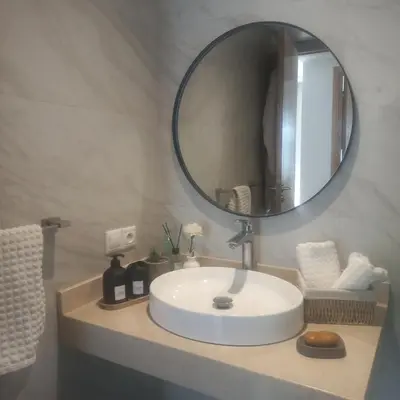 a bathroom with a white sink and a mirror at Puerto Marina Dar Bouazza in Dar Bouazza