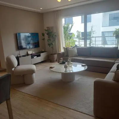 a living room with a couch and a table at Puerto Marina Dar Bouazza in Dar Bouazza