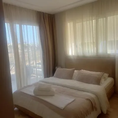 a bedroom with a bed with a large window at Puerto Marina Dar Bouazza in Dar Bouazza