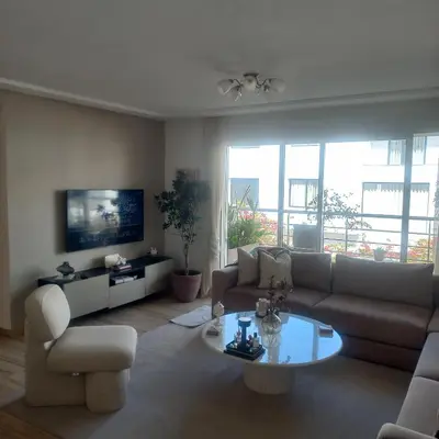 a living room with a couch and a table at Puerto Marina Dar Bouazza in Dar Bouazza