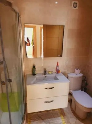 a bathroom with a sink and a toilet and a mirror at Beach condo at Casabay plage Sidi Rahal in Casablanca