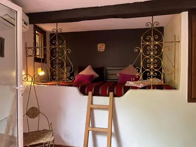 a bunk bed with a ladder in a room at Lovely flat in nice garden in Rabat