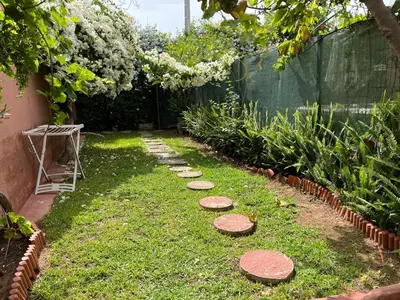 a garden with stepping stones on the grass at Lovely flat in nice garden in Rabat