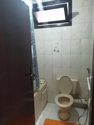 a small bathroom with a toilet and a window at إقامة الياسمين in Rabat