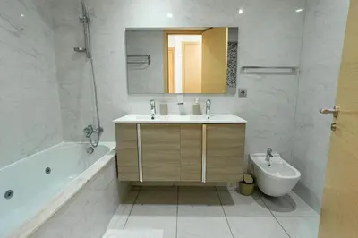 a bathroom with a sink and a tub and a toilet at Appartement avec piscine in Rabat