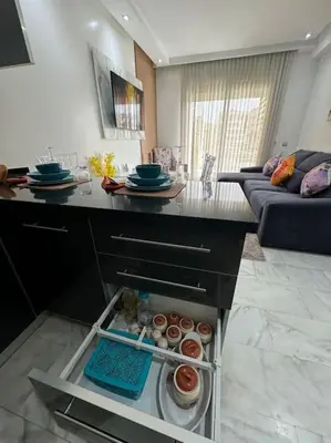 a kitchen with an open cabinet with food in it at Front of beach apartment marina yakht 2 in Casablanca