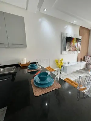 a kitchen with a table with blue dishes on it at Front of beach apartment marina yakht 2 in Casablanca