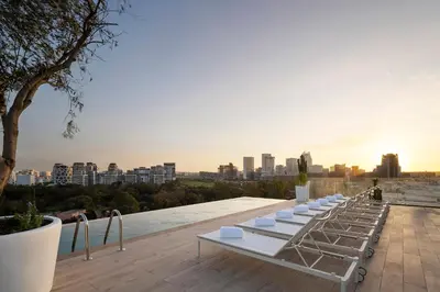 a row of white lounge chairs on top of a building at Eurostars Casa Anfa in Casablanca