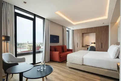 a hotel room with a bed and a couch at Eurostars Casa Anfa in Casablanca