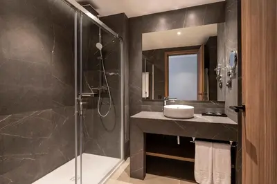 a bathroom with a sink and a glass shower at Eurostars Casa Anfa in Casablanca