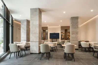a waiting room with tables and chairs and a tv at Eurostars Casa Anfa in Casablanca