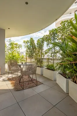 a patio with a table and chairs and plants at Harmony Garden in Casablanca