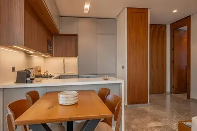 a kitchen with a wooden table and a kitchen counters at Harmony Garden in Casablanca
