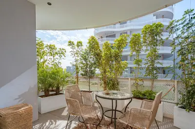 a balcony with a table and chairs and a building at Harmony Garden in Casablanca