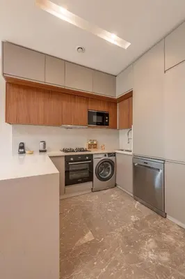 a kitchen with a stove and a washer and dryer at Harmony Garden in Casablanca
