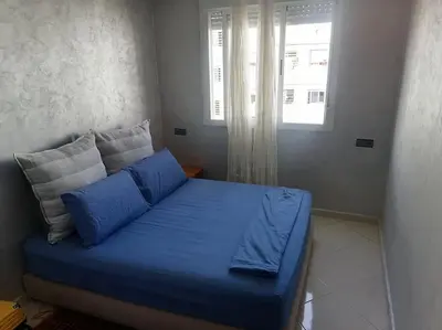 a blue couch in a room with a window at Omarex in Casablanca