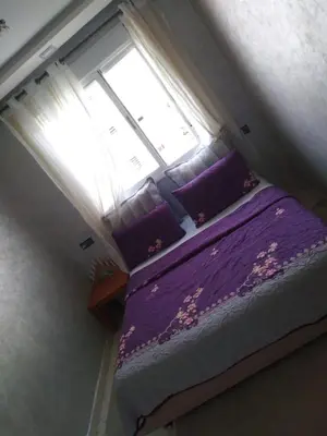 a bedroom with a purple bed with a window at Omarex in Casablanca