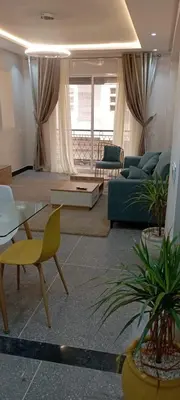 a living room with a couch and a table at Appart RABAT AGDAL in Rabat