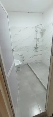 a white bathroom with a toilet and a sink at Appart RABAT AGDAL in Rabat